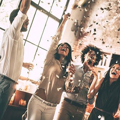 Memorable office moment where coworkers are celebrating with confetti in the office.